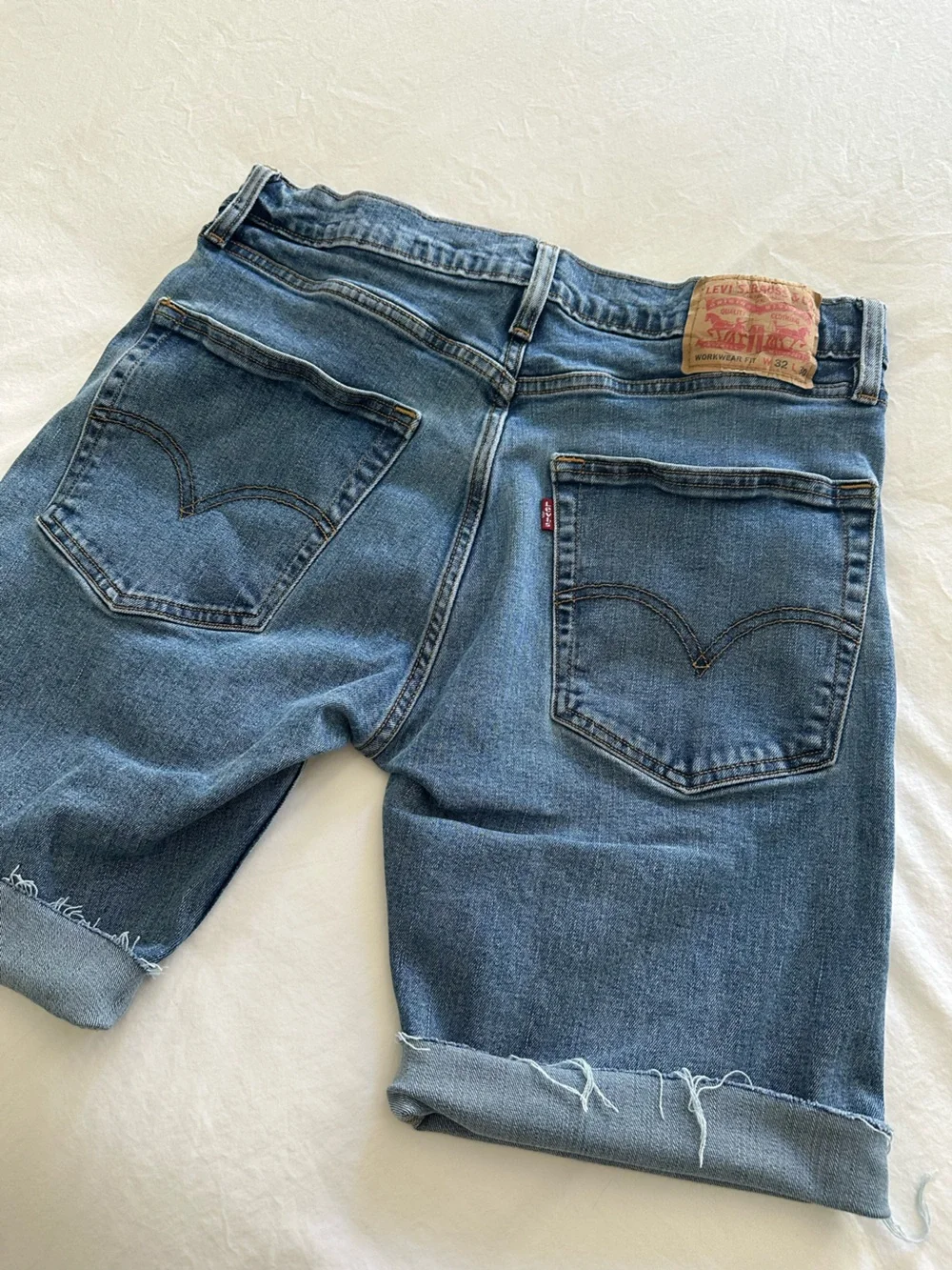 Levi's blue long cut off shorts, size 32